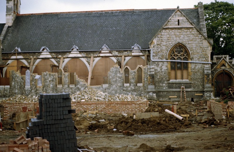 Photo of the exposed north wall following the moving of the stained glass windows (now boarded up)