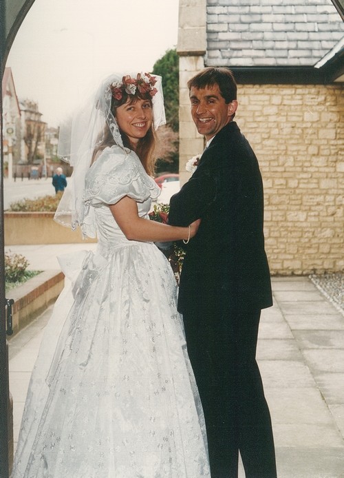 Photo from the wedding of Jon and Helen Cook under the arched doorway as they leave the church