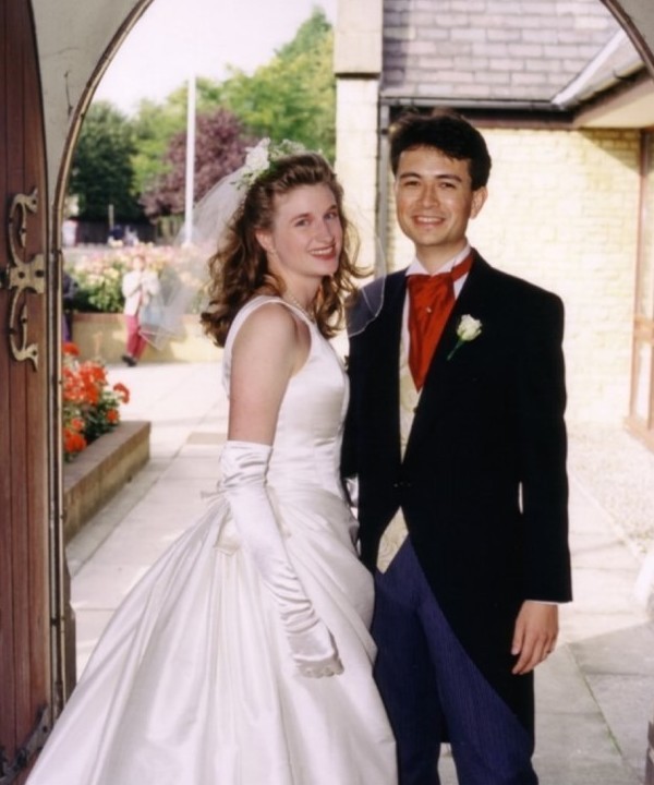 Photo from the wedding of Mike and Esther Ferguson under the arched doorway as they leave the church